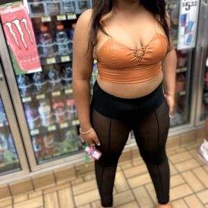 Two-piece brown leather top and see through black tights